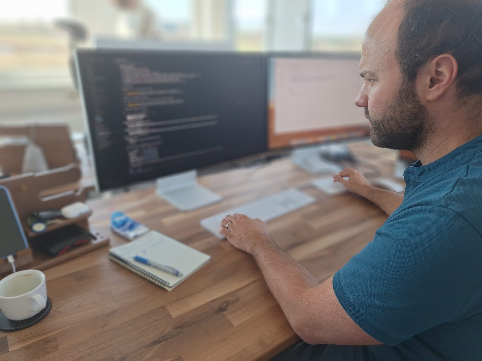 Patrick Bäurer am Rechner mit geöffnetem KI-Coding-Tool Cursor.